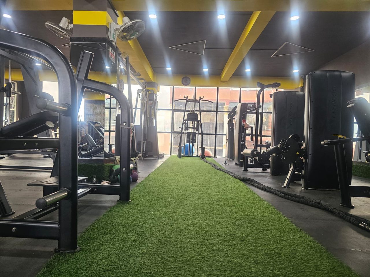 Functional training turf lane with battle ropes and sled at Body Workshop