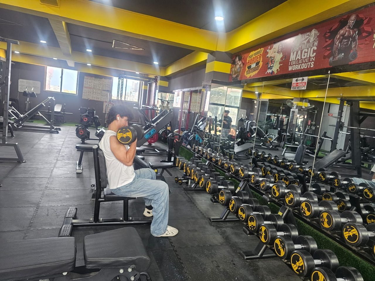 Strength training floor with benches and dumbbells at Body Workshop