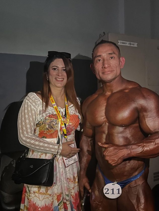 Body Workshop athlete backstage with a supporter at a bodybuilding competition