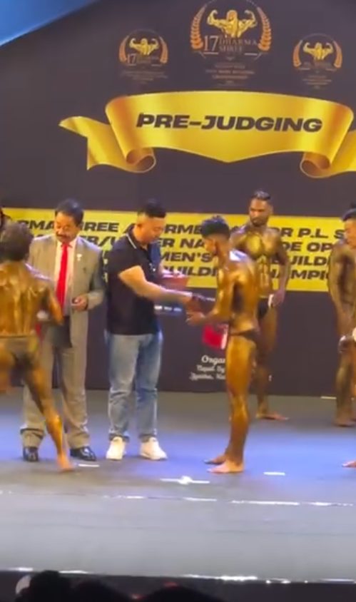 Bodybuilding competitors lined up on stage during pre-judging