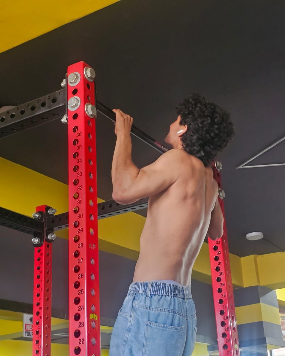 Member performing a pull-up during functional fitness training at Body Workshop